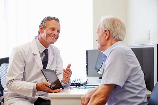 Man learning about the best hearing aids for his hearing loss. 