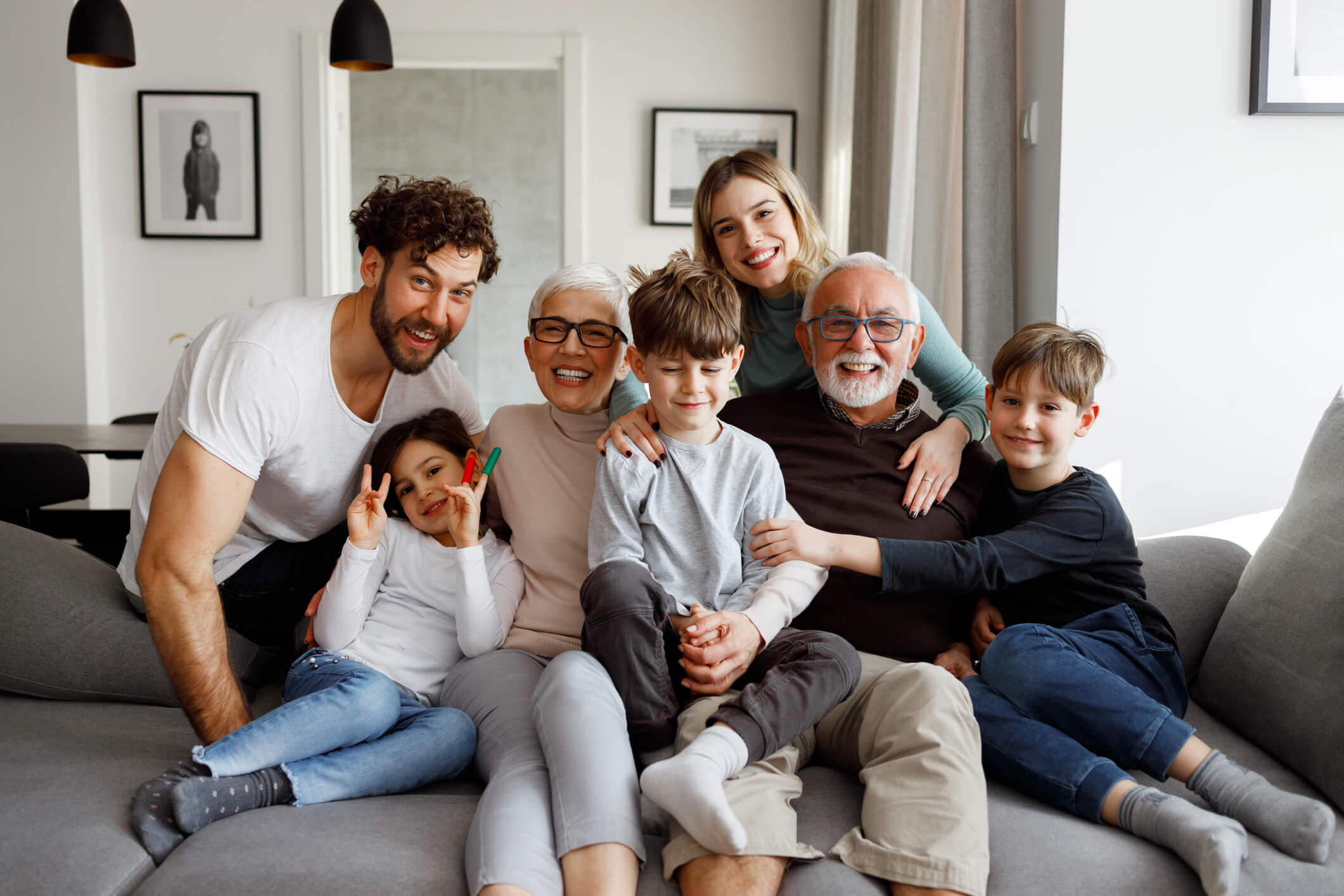 Happy multi-generational family gathered together on the couch